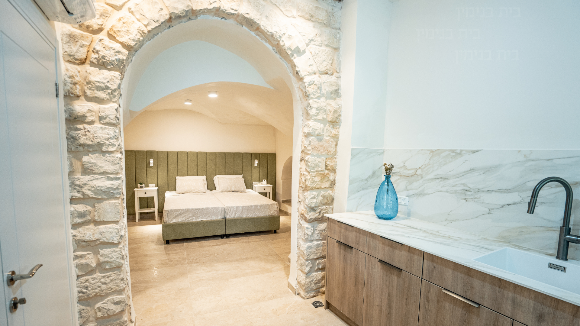Stone-arched bedroom interior at Beit Binyamin